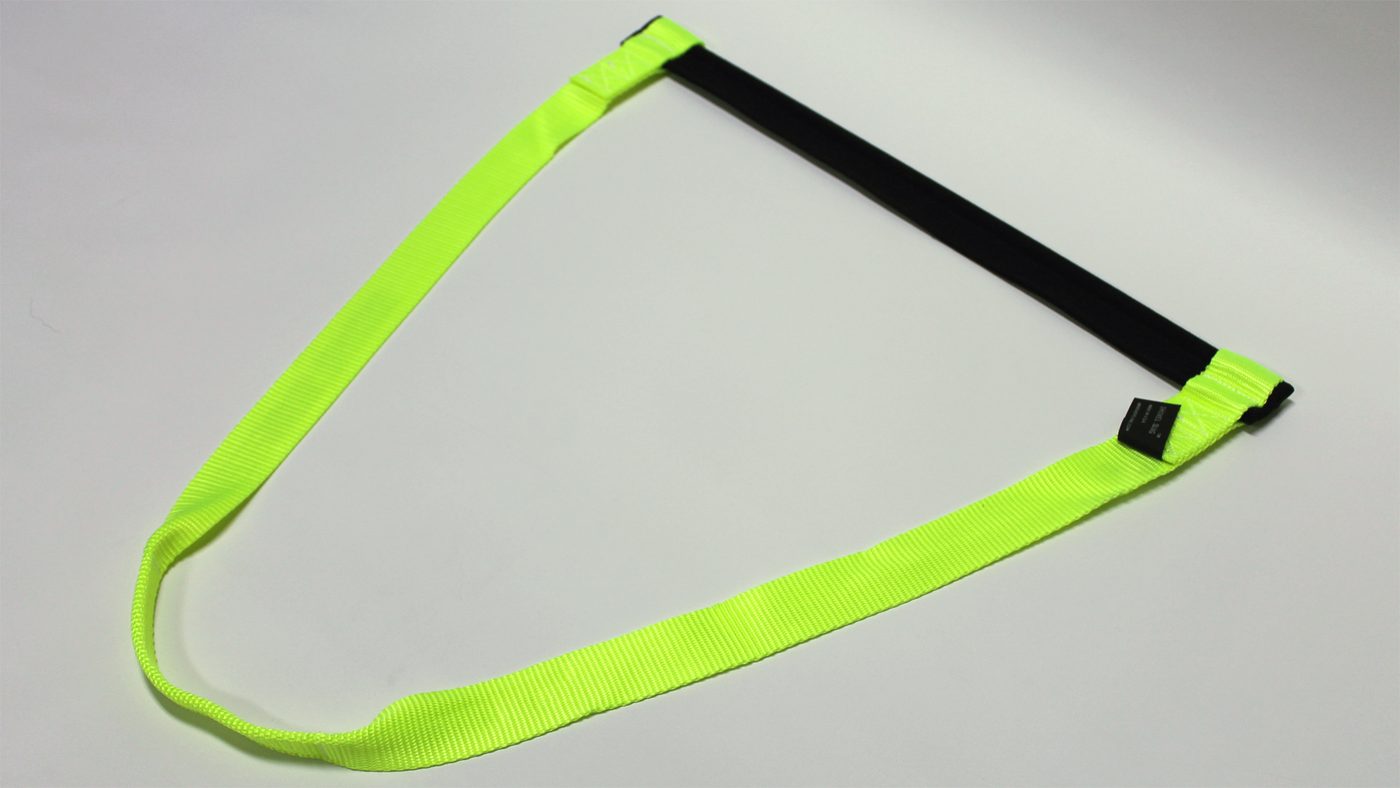 The Shovel Sling, a hi-vis safety green nylon webbing strap with a padded black handle, made in the USA